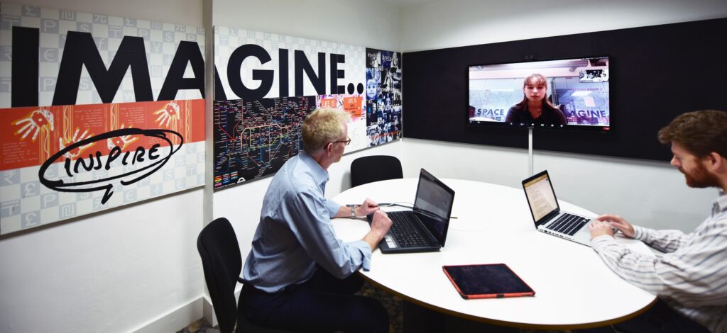 An image of a Zoom meeting taking place in the Hideaway Work Space Video Conferencing Room